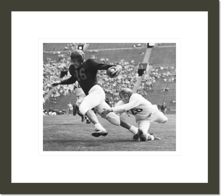 Frank Gifford freeing himself from tackling Johnny Williams in the final spring practice game, University of Southern California