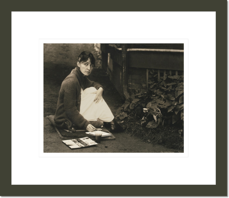 Georgia O'Keeffe [Seated on Ground, Paint Brush in Hand]