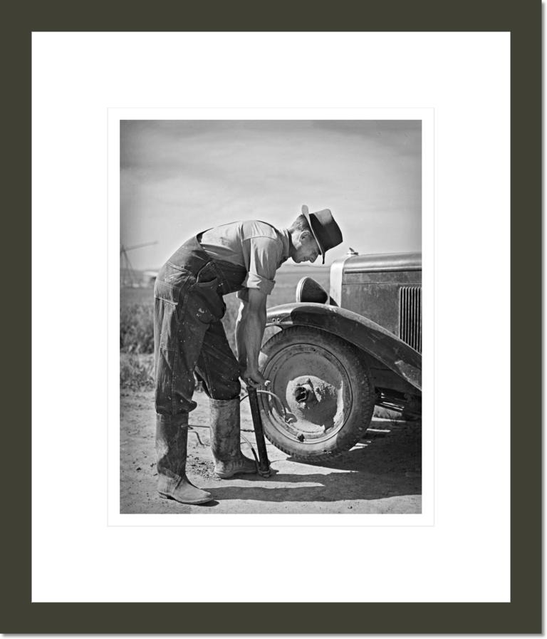 Ray Halstead, FSA (Farm Security Administration) rehabilitation borrower, pumping up a tire. Dead Ox Flat, Malheur County, Oregon